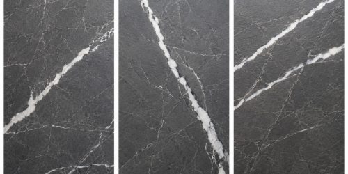 encimera-porcelanico-gran-formato-sevilla Superficie de encimera porcelánica de gran formato en gris oscuro con veta blanca y acabado mate.